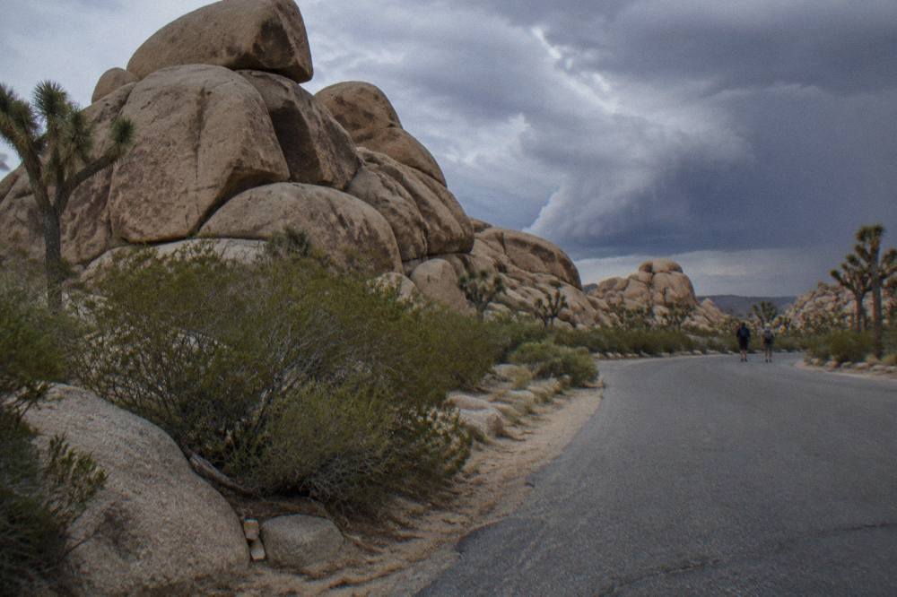 Granite boulder formations stacked beside a paved desert road